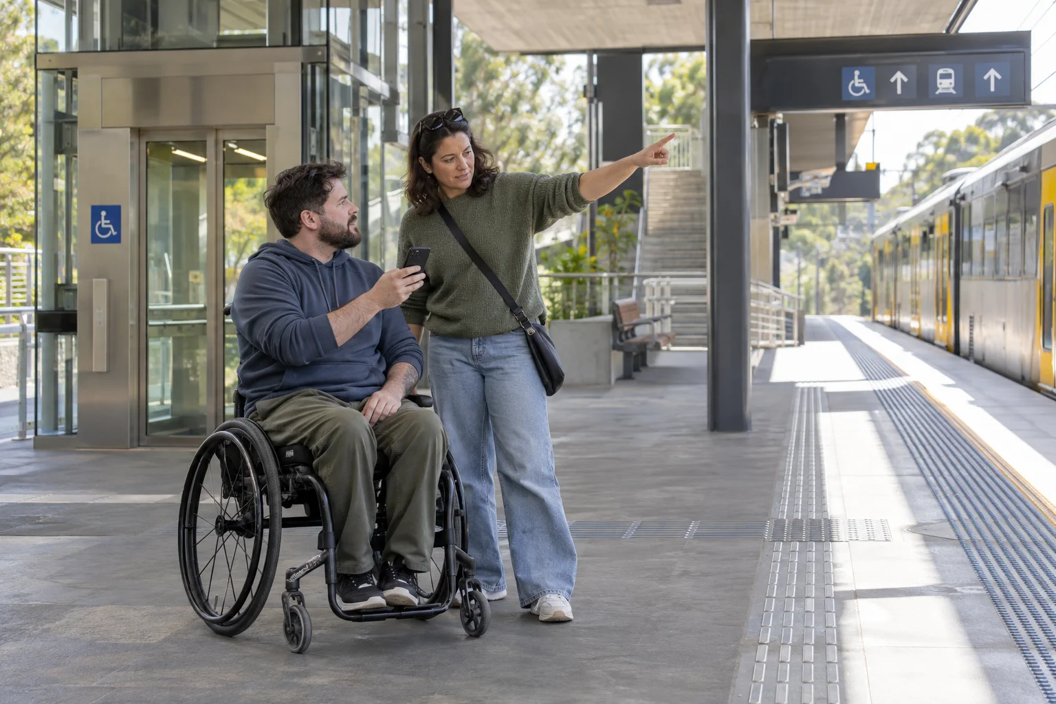 Two adults planning an accessible train journey together.
